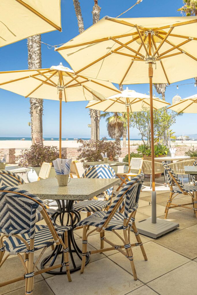 Outdoor dining tables with umbrellas under the Santa Monica sun.