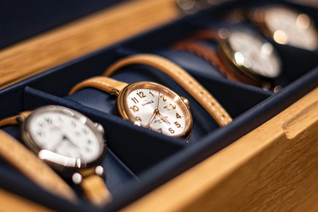 A wooden tray of luxury watches.