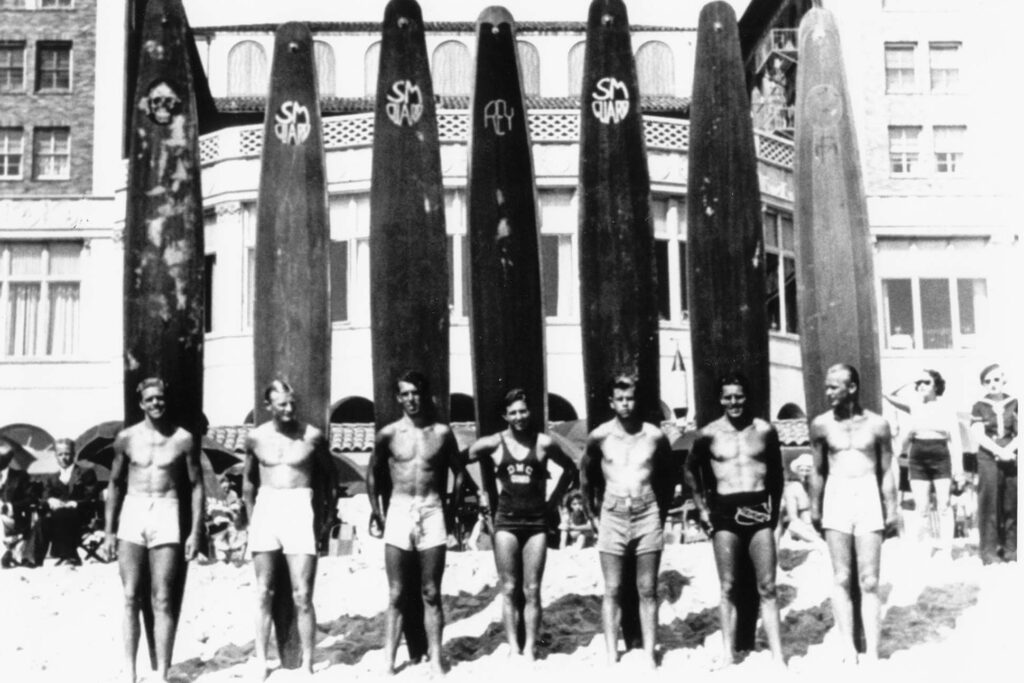 Above: Beachgoers at Club Casa del Mar, undated. Men with surf boards on Santa Monica Beach in front of the Casa del Mar, a well known beach club amongst leading business executives and Hollywood celebrities. Undated.