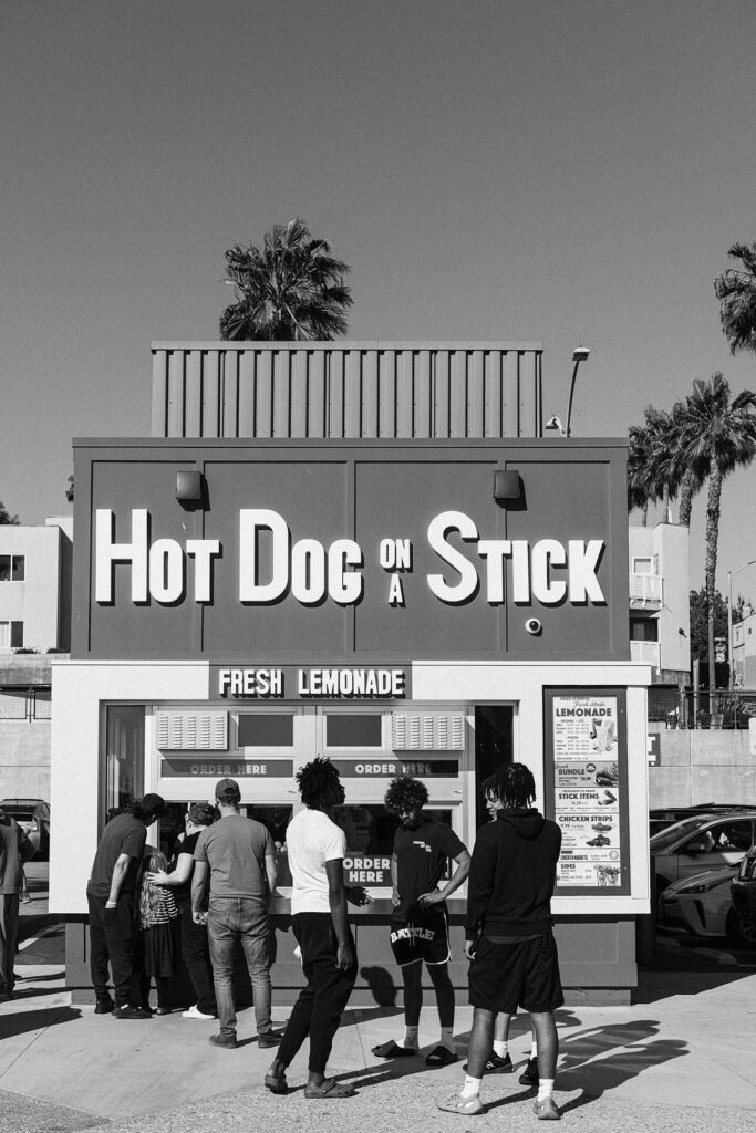 The famed Hot Dog Stick on the Pier. This page, 1960. Next page, 2023.