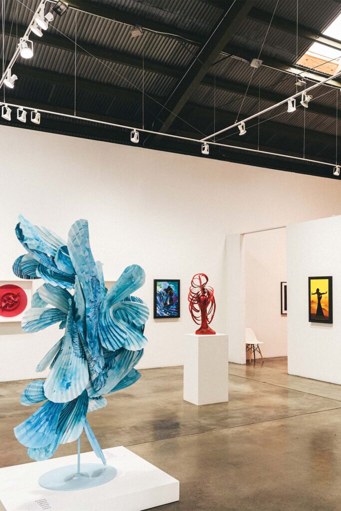 a large art gallery with several pieces of art on display