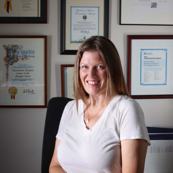 a person sitting in a chair with a certificate